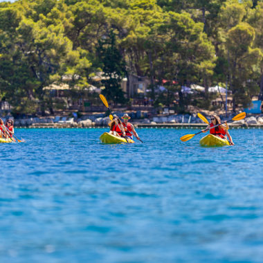 A Front View of Sea Kayakers, expertly navigating the blue Adriatic Sea.