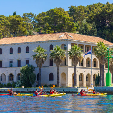 Kayakers navigating waters near Split's Oceanography and Fisheries Institute