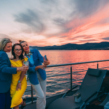 Guests enjoying a scenic sunset cruise and photographing